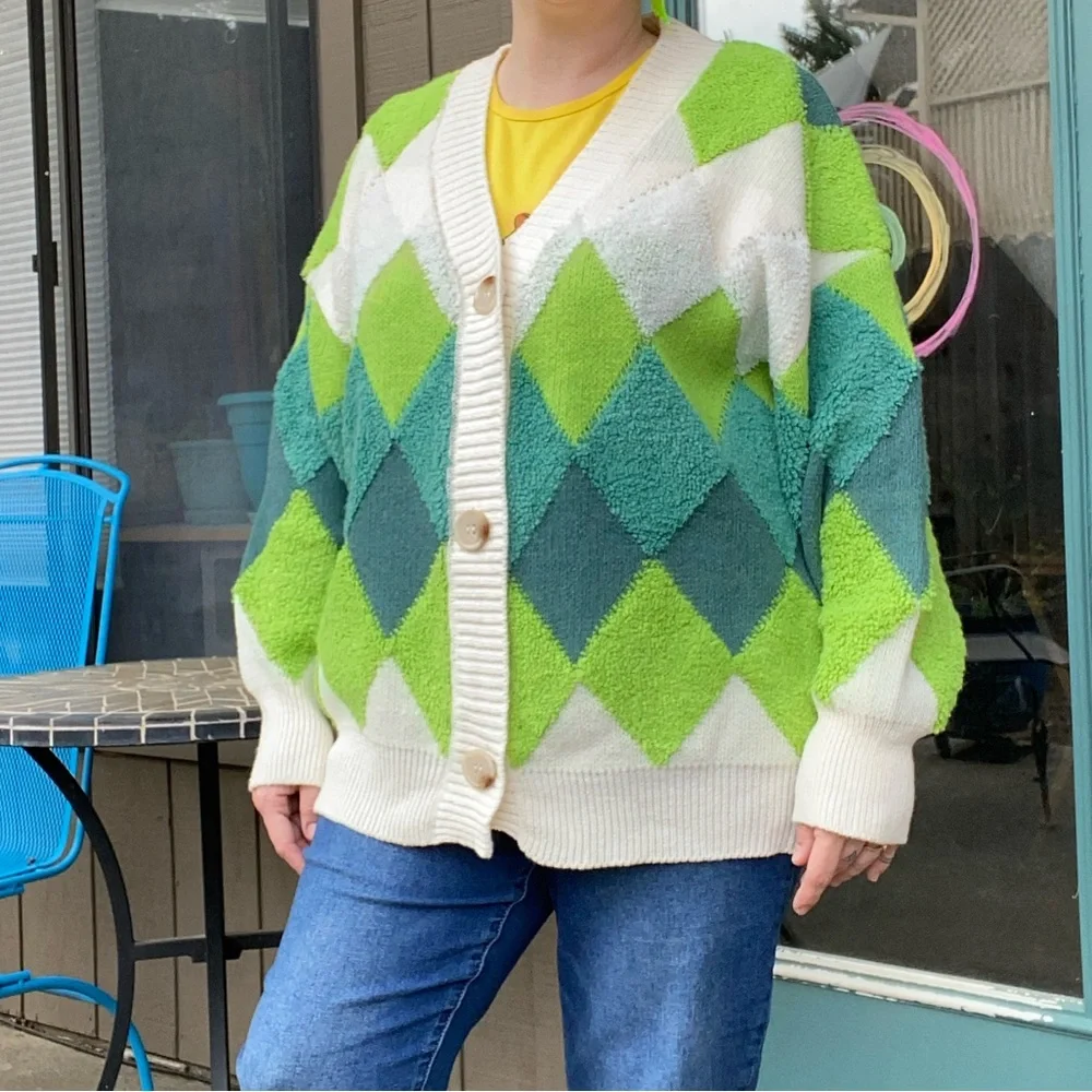 Green and cream harlequin patterned button up sweater